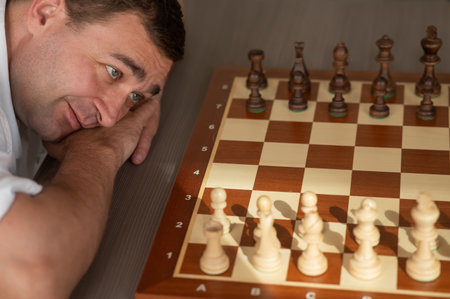 Middle aged Caucasian man playing chessの写真素材