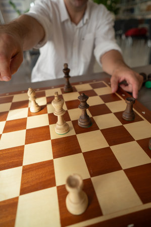 Close up of hands of middle aged caucasian man playing chessの写真素材