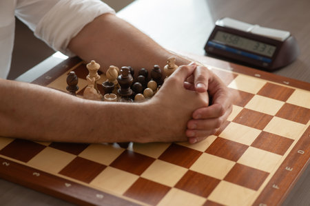 Close up of hands of middle aged caucasian man playing chessの写真素材