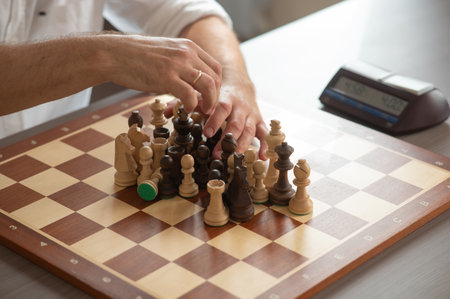 Close up of hands of middle aged caucasian man playing chessの写真素材