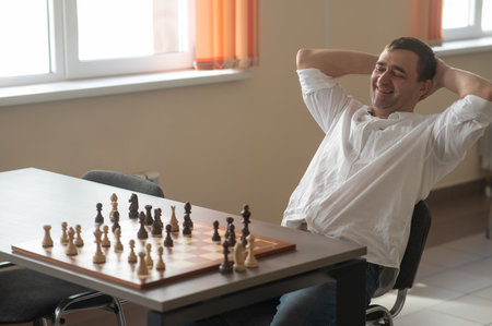 Caucasian man thinking about a chess moveの写真素材