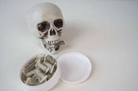 Skull Chewing Tobacco on a White Tableの写真素材