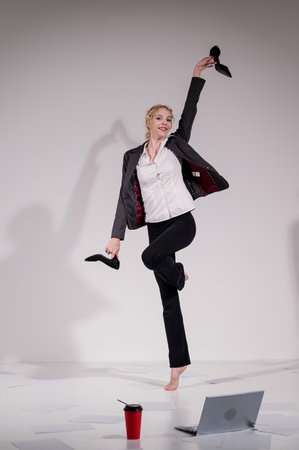 Barefoot ballerina dancing in business suit on white backgroundの写真素材