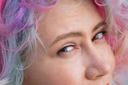 Close-up portrait of Caucasian woman with multi-colored hairstyleの写真素材
