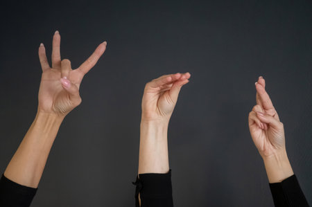 Russian Sign Language. Close-up of hands on black backgroundの写真素材