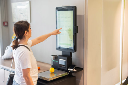 Woman weighing a lemon at a self-checkout