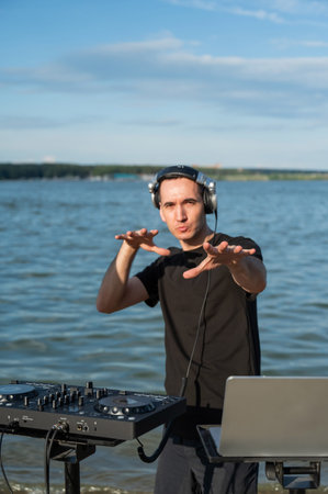 Caucasian man works as a DJ on the beach