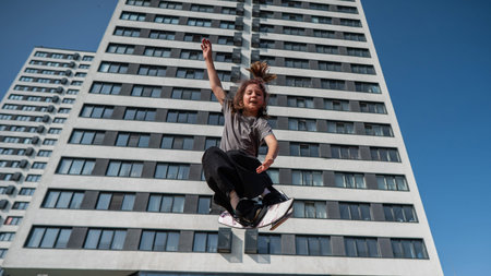 Girl practices tricks on a trampoline