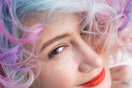 Close-up portrait of Caucasian woman with multi-colored hairstyle