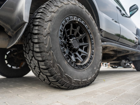 Close-Up of a Rugged Off-Road Tire on a Black SUV