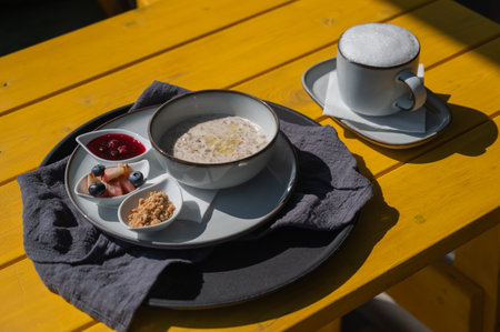 Reserved breakfast at a cafe. A plate of porridge on a table in a street cafeの写真素材