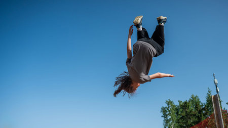 A girl jumps on an outdoor trampoline