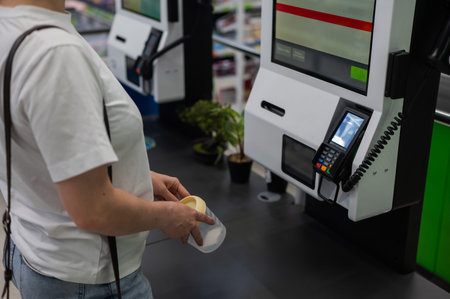 A woman scans items at a self-checkout
