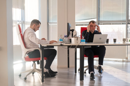 Two Caucasian men working in an office