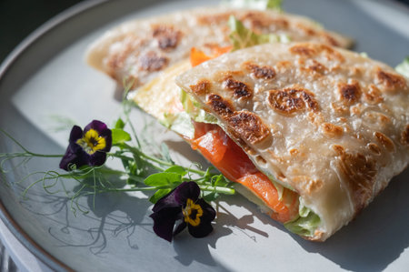 A flatbread stuffed with fish and cheese served in a cafe.