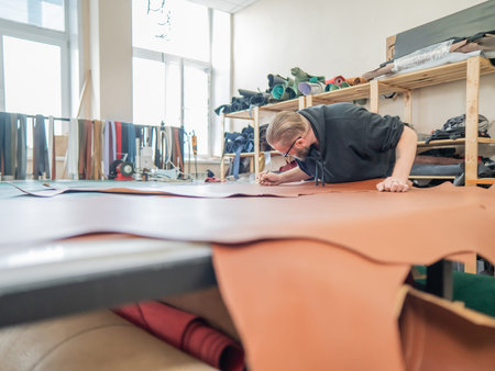 Caucasian bearded man working as a tanner in a workshop