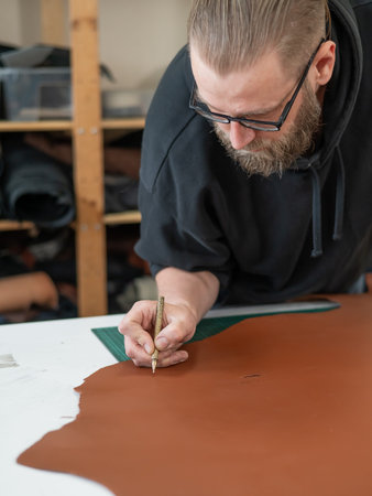 Bearded man working as a tanner in a workshop