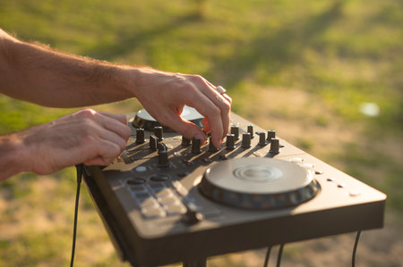 Close up of DJs hands outdoors