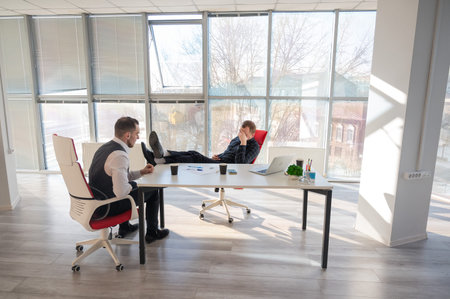 Two Caucasian men negotiating in an office