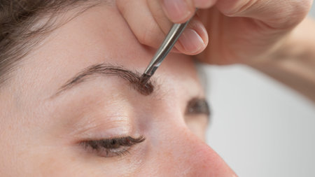 Caucasian woman getting eyebrow tinting procedure