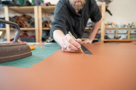 Caucasian bearded man working as a tanner in a workshop