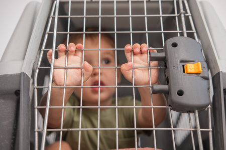 A small child in a closed cage