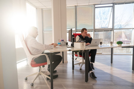 Two Caucasian men working in an office