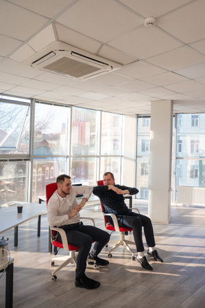 Two Caucasian men having fun at work