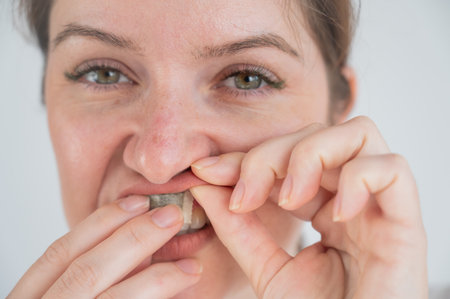 A woman uses chewing tobaccoの写真素材