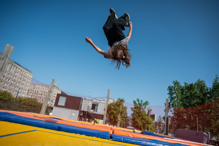 A girl jumps on an outdoor trampoline