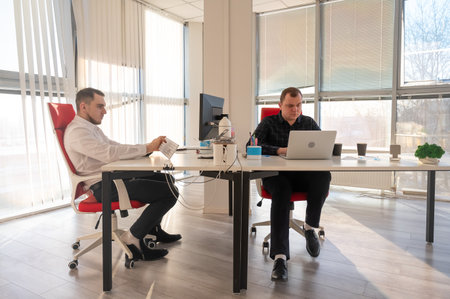 Two Caucasian men working in an officeの写真素材