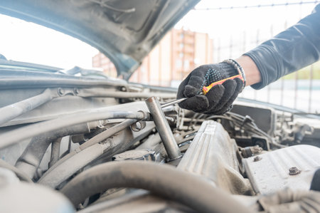 A man changes spark plugs in his carの写真素材