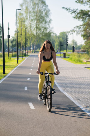 Curvy Woman Riding Bicycle in Park