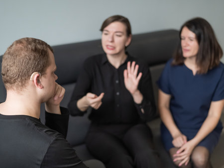 A man and two women are talking in Russian sign languageの写真素材