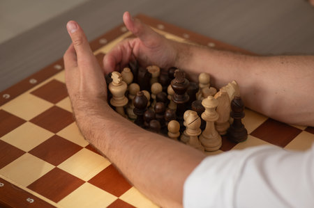 Close up of hands of middle aged caucasian man playing chessの写真素材