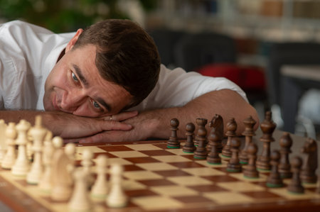 Middle aged man playing chessの写真素材