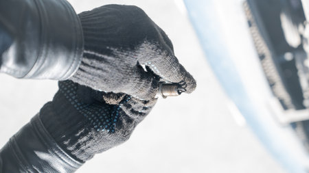 Caucasian man changing spark plugs in carの写真素材