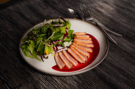 Roasted duck cut into pieces on a plateの写真素材