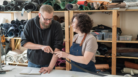A man and a woman work as tanners in a workshop
