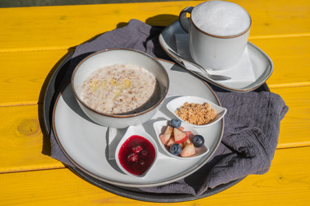 Reserved breakfast at a cafe. A plate of porridge on a table in a street cafeの写真素材