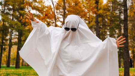 Woman in a ghost costume against the backdrop of an autumn forest. Halloween costumeの写真素材