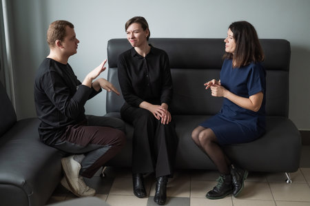 A man and two women are talking in Russian sign languageの写真素材