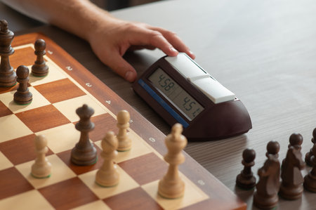 Close up of hands of middle aged caucasian man playing chessの写真素材