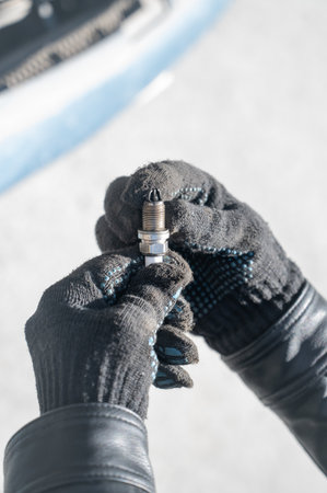 Caucasian man changing spark plugs in carの写真素材
