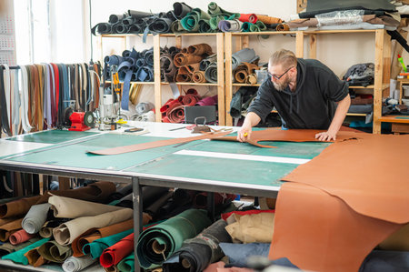 Caucasian bearded man working as a tanner in a workshop
