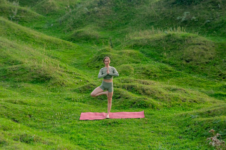 Caucasian woman doing yoga outdoors. Tree poseの写真素材