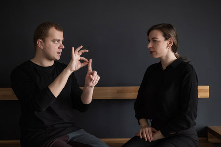A man and a woman are talking in Russian sign language