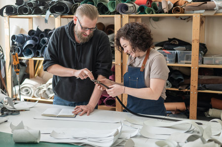 A man and a woman work as tanners in a workshop