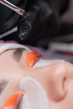 Caucasian woman undergoing eyelash lamination procedure