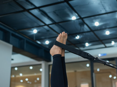 Caucasian woman doing exercises on reformer machine
